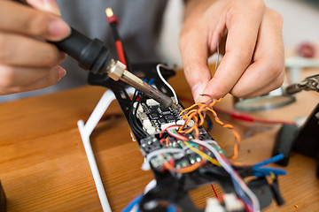 Image showing Man welding parts on drone body