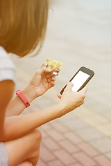 Image showing Woman using phone and card for shopping