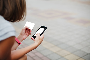 Image showing Woman using phone and card for shopping