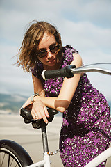 Image showing Dreaming girl posing with bicycle