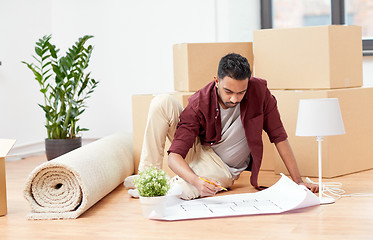 Image showing man with blueprint and boxes moving to new home