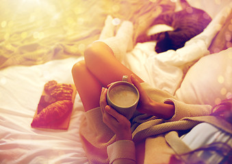 Image showing close up of woman with cocoa cup in bed