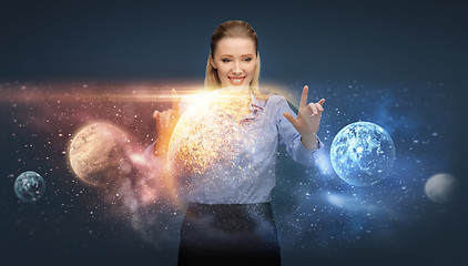 Image showing happy businesswoman with virtual planets and space