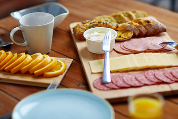 Image showing cream cheese and other food on table at breakfast