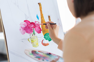 Image showing artist with brush painting still life at studio