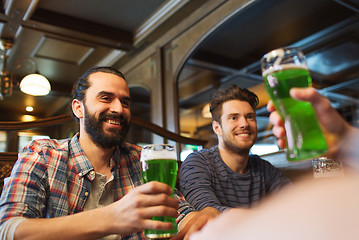 Image showing male friends drinking green beer at bar or pub