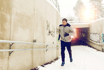 Image showing man running out of subway tunnel in winter