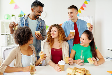 Image showing happy friends or team eating at office party