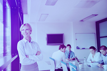 Image showing business woman with her staff in background at office