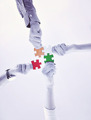 Image showing Group of business people assembling jigsaw puzzle