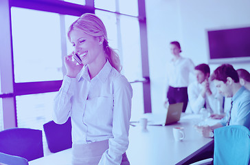 Image showing business woman with her staff in background at office