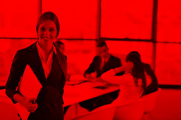 Image showing business woman with her staff in background at office