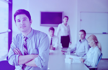 Image showing business man  on a meeting in offce with colleagues in backgroun