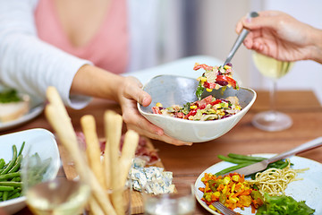 Image showing people eating salad at table with food