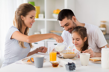 Image showing happy family having breakfast at home