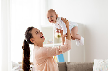 Image showing happy mother playing with little baby boy at home