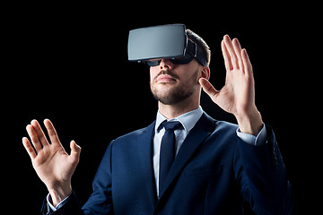 Image showing businessman in virtual reality headset over black