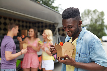 Image showing happy man with wok and friends at food truck