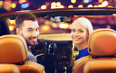 Image showing happy couple sitting in car at auto show or salon
