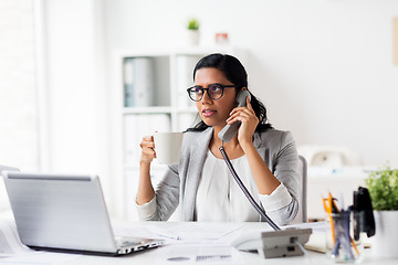 Image showing businesswoman calling on phone at office