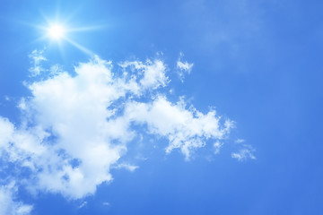 Image showing bright blue sky with sun and clouds background