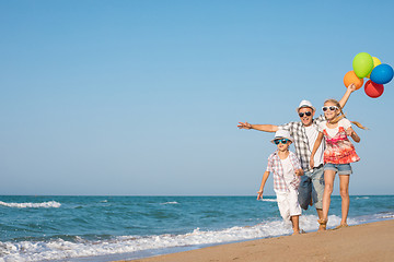 Image showing Father and son and daughter playing on the beach at the day time