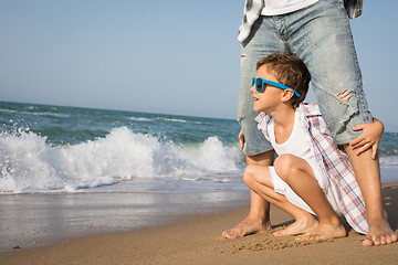 Image showing Father and son playing on the beach at the day time.