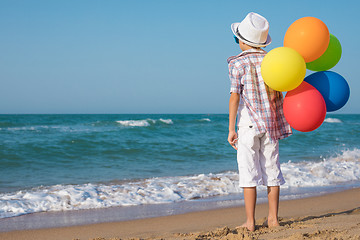 Image showing One happy little boy playing on the beach at the day time.