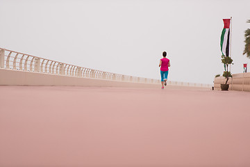 Image showing woman busy running on the promenade