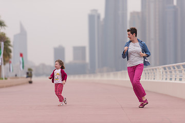 Image showing mother and cute little girl on the promenade