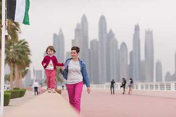 Image showing mother and cute little girl on the promenade