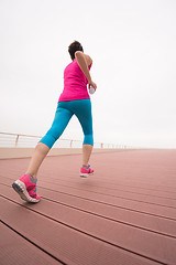 Image showing woman busy running on the promenade