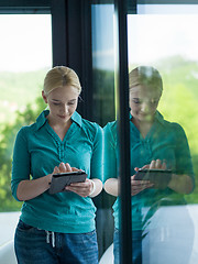 Image showing young women using tablet computer by the window