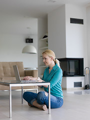 Image showing young women using laptop computer on the floor