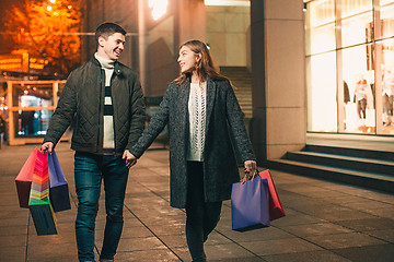Image showing The happy couple with shopping bags enjoying night at city background