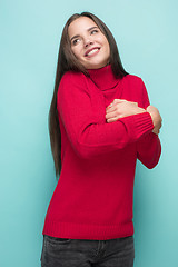 Image showing Portrait of happy young woman holding a gift isolated on white