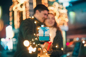 Image showing romantic surprise for Christmas, woman receives a gift from her boyfriend