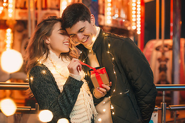 Image showing romantic surprise for Christmas, woman receives a gift from her boyfriend