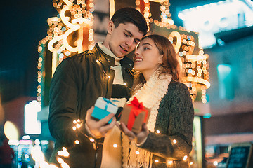 Image showing romantic surprise for Christmas, woman receives a gift from her boyfriend