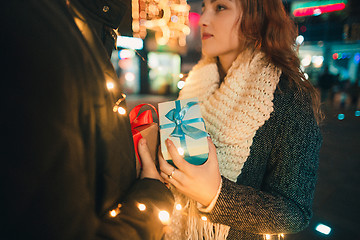 Image showing romantic surprise for Christmas, woman receives a gift from her boyfriend