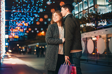 Image showing The happy couple with shopping bags enjoying night at city background