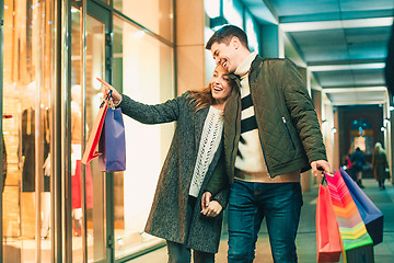 Image showing The happy couple with shopping bags enjoying night at city background