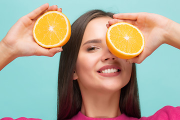 Image showing Beautiful woman\'s face with juicy orange