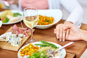 Image showing hands of people at table praying before meal