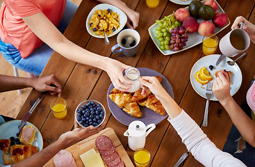 Image showing people having breakfast at table with food