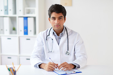 Image showing doctor with stethoscope and clipboard at clinic