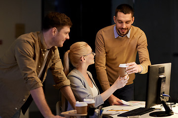 Image showing business team with computer working late at office