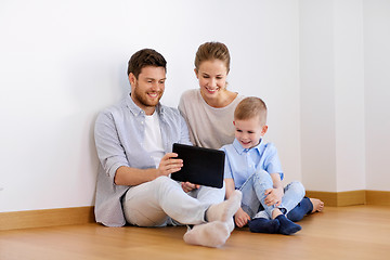 Image showing happy family with tablet pc moving to new home