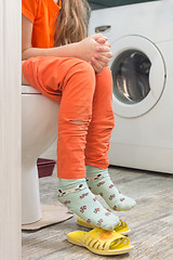 Image showing Little girl is sitting on the toilet in the bathroom