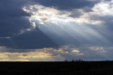 Image showing The sun shining through clouds